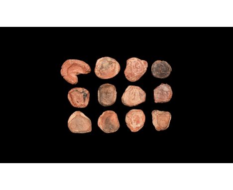 1st-3rd century AD. A mixed group of discoid ceramic theatre tokens or seals with impressed motifs from intaglio matrices, ma