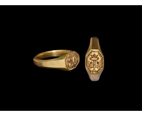 15th century AD. A gold finger ring comprising a facetted D-section hoop, expanding shoulders, octagonal bezel with beaded bo