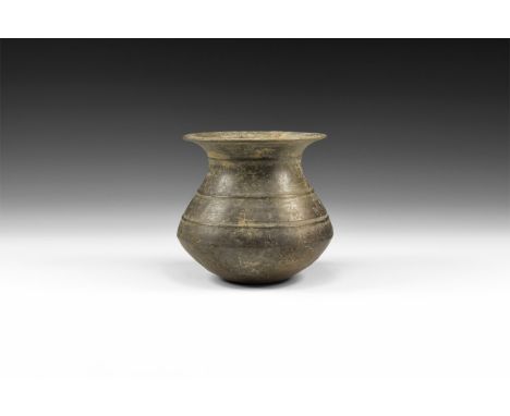 1st millennium BC. A ceramic grey ware burnished pot with flared rim, bulbous body with horizontal lines, small, flat base.  