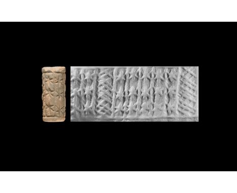 15th-13th century BC. A ceramic cylinder seal with remains of glaze and geometric decoration, accompanied by an old scholarly