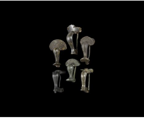 2nd century AD. A mixed group of bronze knee brooches, one with hinged pin, five with sprung pins. See discussion in Mackreth