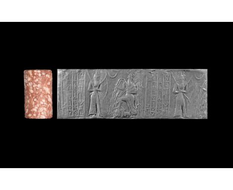 Akkadian II, 2294-2270 BC. A fossiliferous limestone cylinder seal with a warlike god in slash-skirt, armed with a barrow in 