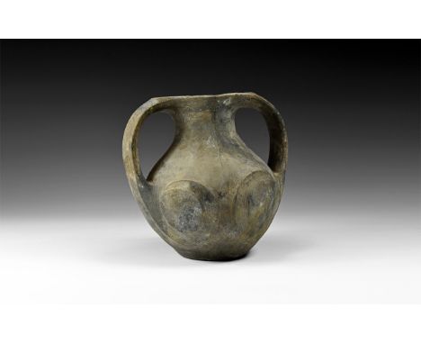 Warring States, 475-221 BC. A painted ceramic greyware jar with globular body and vessica-shaped rim, two strap handles exten