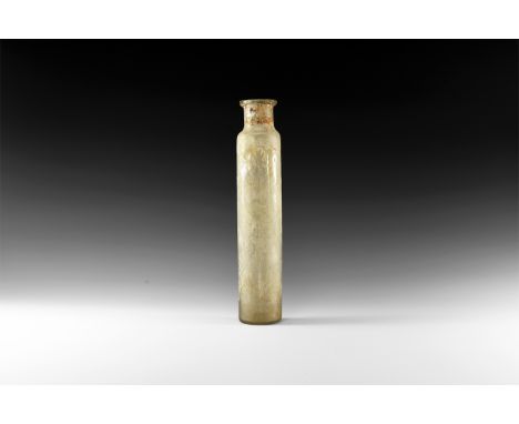 8th-10th century AD. A tubular glass flask with rough pontil base, steep shoulder, applied rim, some iridescence to the surfa