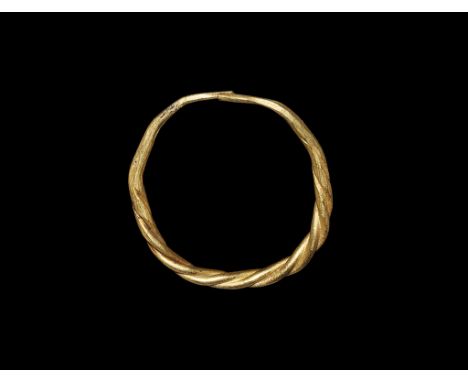 9th-11th century AD. A penannular hoop of gold rods twisted around each other, tapering and butted to the rear. Cf. Oman, C.C