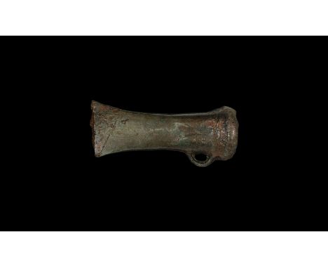 2nd millennium BC. A Sompting Type socket axehead with loop and distinctive double crescentic ridged decoration. Cf. Schmidt,