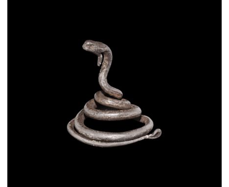 Ptolemaic Period, 332-30 BC. A silver model the snake deity Agathadaimon with coiled body, raised head with punched eye and b
