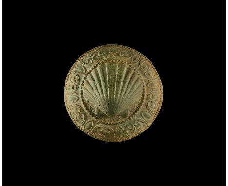 16th century AD. A bronze oval and dome-shaped fitting with border of pelta shaped floral motif and oval shields; to the cent