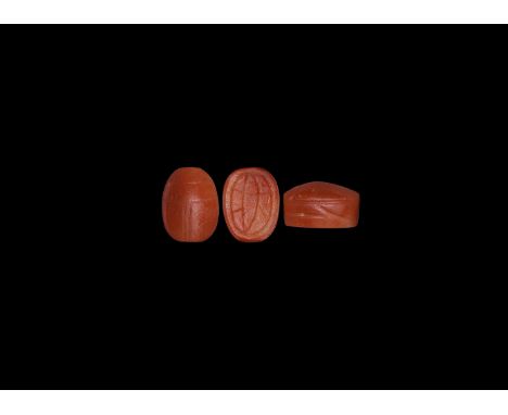 Late Period, 664-332 BC. A carnelian scarab with incised carapace detail to upper and lower face. Cf. Flinders Petrie, W.M. A
