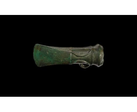 7th century BC. A Sompting Type socketted axehead with loop and distinctive double crescentic ridged decoration, large bulbou