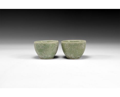 Ming Dynasty, 1368-1644 AD. A pair of green glazed ceramic tea cups with small rim and thick walled bodies; small foot ring t