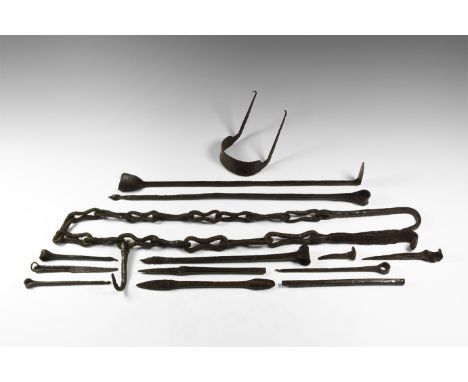 10th-12th century AD. A large mixed group of iron tools comprising of: a massive chain with a hook on each end, a long rod wi