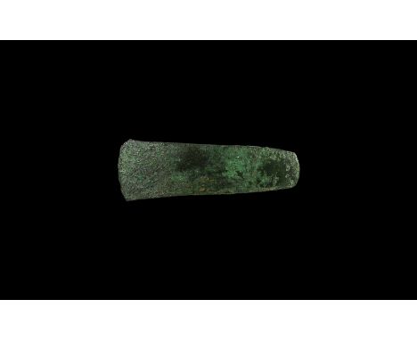 18th-16th century BC. A small bronze flat axe of flared profile with rounded butt. Cf. Evans, J. The Ancient Bronze Implement