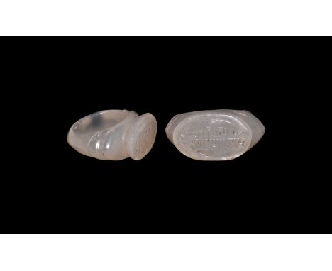 11th-12th century AD. A chalcedony ring with D-section shank, two lobes at the shoulder; raised oval bezel engraved with Arab