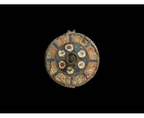 2nd century AD. A discoid plate brooch with central cup and knop, loop to the rim, enamelled field with six roundels surround