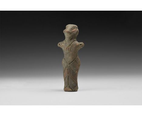 6th-4th millennium BC. A ceramic figurine of a standing female with prominent nose, short extended arms, incised details to n