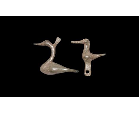 1st-2nd century AD. A mixed bronze group comprising: a bird with long beak, flared tail, pierced lug beneath; a bird with lon