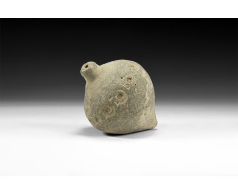 9th-11th century AD. A hollow-formed piriform ceramic vessel with low rim to the mouth; ring of impressed annulets to the sho