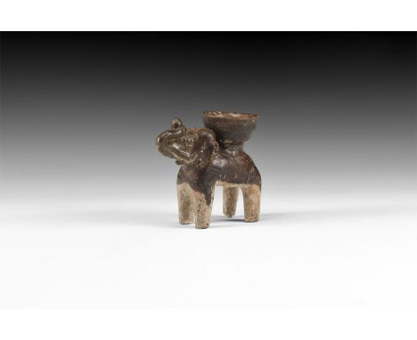 14th-16th century AD. A Sukhothai black glazed ceramic figure of an elephant, trunk curving up and holding object to head, cu