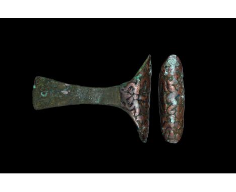 3rd millennium BC. A bronze axehead with narrow straight blade, slightly flaring towards the cutting edge, the shaft decorate