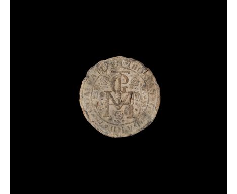 16th-17th century AD. A flat discoid lead seal with monogram containing letters M, G and T surrounded by three roses, legend 