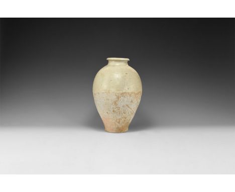 Song Dynasty, 960-1279 AD. A tall ceramic whiteware vase of piriform profile with short neck and rolled rim, part-glazed.  1.