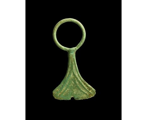 8th-12th century AD. A bronze pendant in the form of an axe with ribbed surface and large integral suspension loop.  10 grams