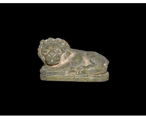 Second Intermediate Period, 1650-1550 BC. A steatite(?) amulet of a reclining lion on a base, head turned to the left. Cf. An