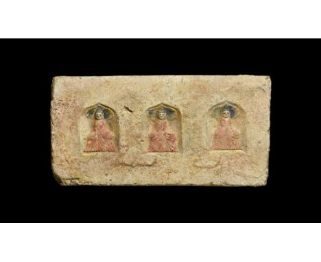Northern Wei Dynasty, 386-535 AD. A ceramic rectangular brick with three niches with pointed arches; within each a seated fig