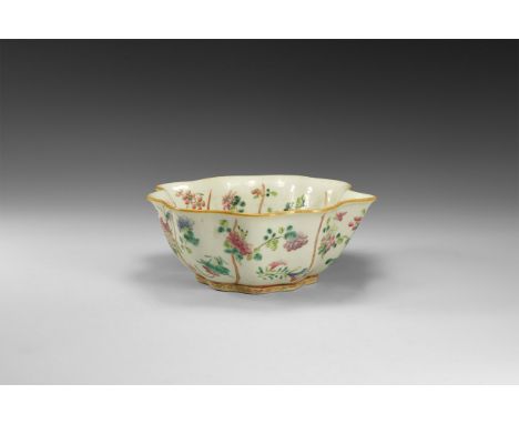19th century AD. A white-glazed ceramic bowl shaped like a leaf with polychrome blossom and branches, red chop seal to the un