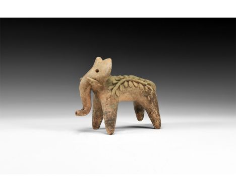 19th century AD. A ceramic figure of a standing elephant with curving trunk, short tusks and impressed eyes; applied decorati