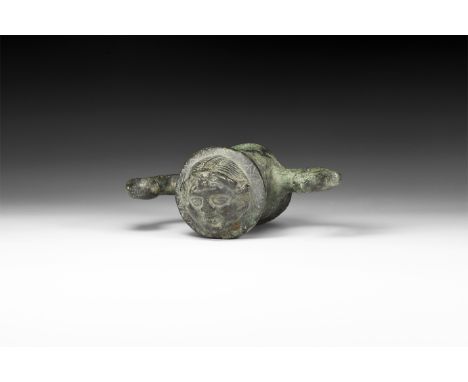 1st-2nd century AD. A hollow-formed bronze rein guide comprising: a tubular shaft with flared base and rim, flange above with