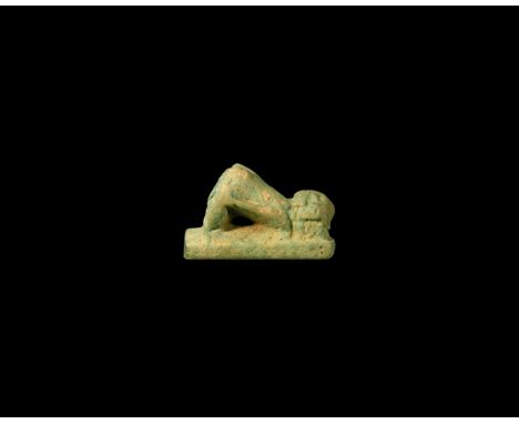 Ptolemaic Period, 332-30 BC. A pale blue glazed composition amuletic figure of a bound captive kneeling on a rectangular base