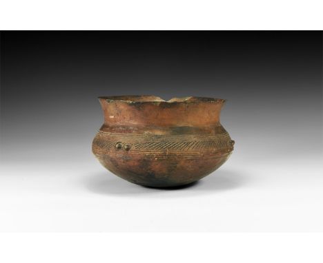 5th-6th century AD. A ceramic bowl of biconical profile with rounded base and flared rim; two linear bands to the shoulder fr