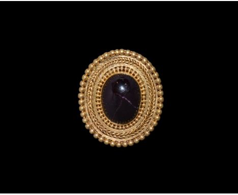 3rd century BC. A substantial discoid gold plaque with granules to the border, ropework band, beaded collar to the central ce