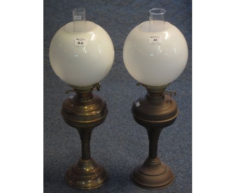 Pair of brass double burner oil lamps with brass reservoirs and pedestal bases, white glass shades with clear chimneys. (2)(B