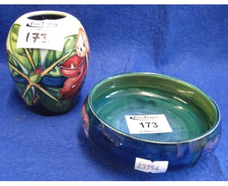 Two pieces of Moorcroft pottery to include: anemone circular pedestal bowl on blue ground and floral and foliate ovoid vase, 