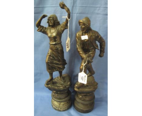 Pair of bronzed spelter figures: fisherman and woman, perched on the bow of boats, on socle bases.  After the French. (2)(B.P