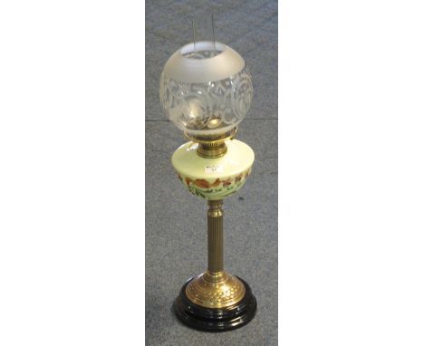 Brass double burner oil lamp, having floral glass reservoir, brass pedestal on black ceramic base with etched glass shade and