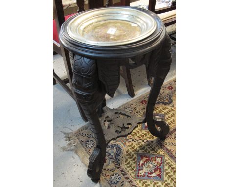 Unusual stained hardwood jardiniere carved with elephants heads and under shelf.(B.P. 24% incl. VAT)