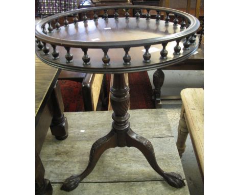 Reproduction mahogany circular tripod table on carved ball and claw feet.(B.P. 24% incl. VAT)