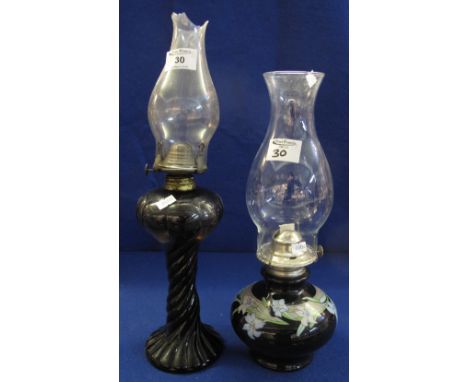 Coloured glass, single burner oil lamp with clear chimney, together with a ceramic single burner oil lamp with floral decorat