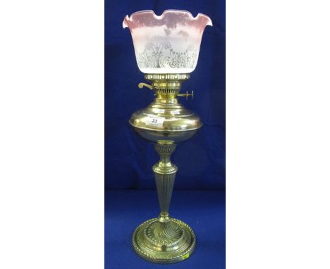 Brass double burner oil lamp with brass reservoir on cast brass base with etched glass shade.(B.P. 24% incl. VAT)