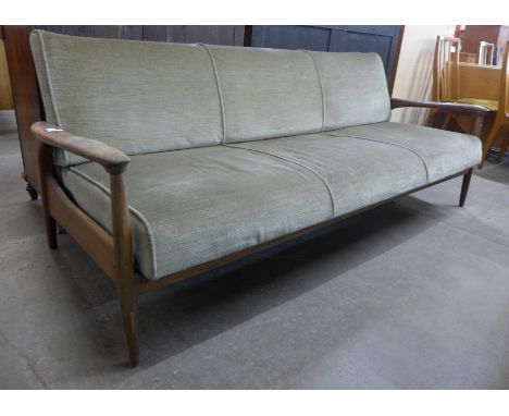 A Guy Rodgers teak and green fabric upholstered settee/daybed. This lot is offered as a work of art, it may not comply with F