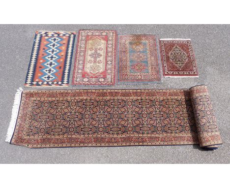 A blue ground runner rug and three other rugs 