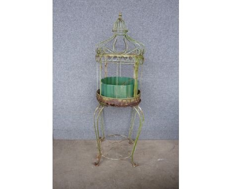 A vintage wrought iron planter on stand 