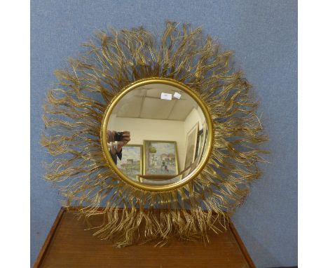 A contemporary circular gilt framed mirror 