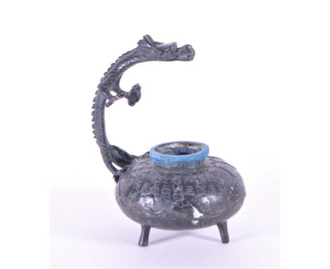20th century Chinese bronze dragon statue incense. Features a dragon standing over a squat pot raised on three feet with the 