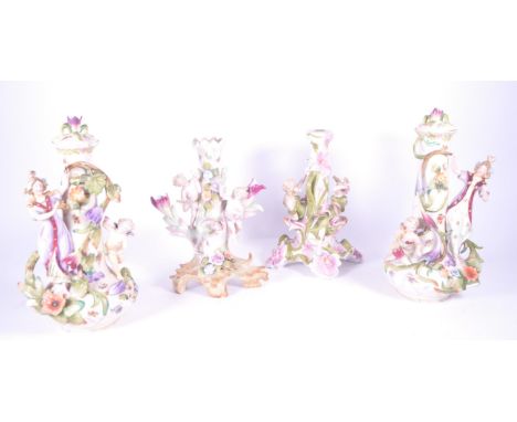 A collection of 19th century German bisque porcelain pottery comprising x2 candlestick holders and x2 lidded vases. Each deco