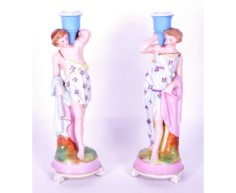 Manner of Meissen - A pair of early 20th century manner of Meissen porcelain candlesticks. Each raised on rounded bases, havi